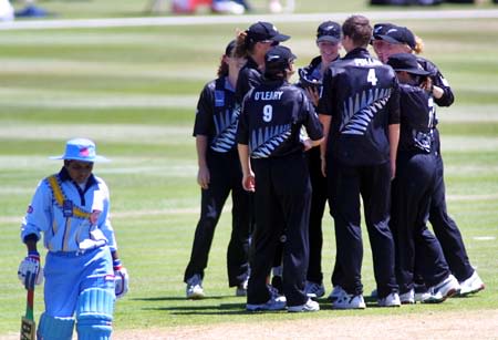 Renu Margrate walks back to the pavilion while New Zealand celebrate Rebecca Rolls' stumping