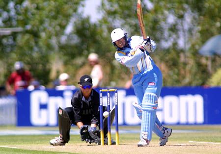 Purnima Rau hits the ball toward the boundary during her innings of 67 not out
