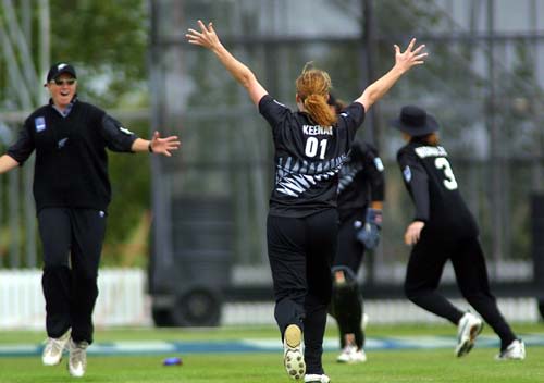 New Zealand bowler Katrina Keenan runs down the wicket with her arms in the air after dismissing Australian opener Lisa Keightley