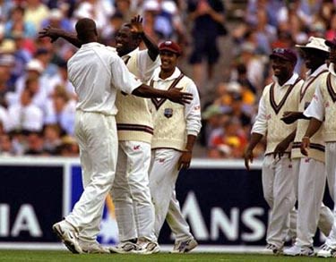 Nixon McLean and Wavell Hinds celebrate the wicket of Ponting