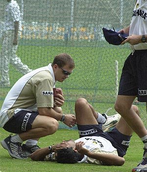 Andrew Leipus assists Anil Kumble during a training session