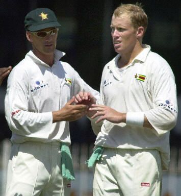 Gary Brent embraces teammate Gavin Rennie after dismissing Sri Lankan batsman Kumar Sangakkara