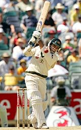Justin Langer lofts one over mid-on